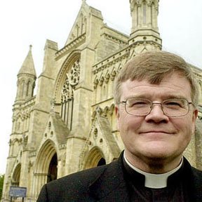 dr-jeffrey-john-poses-outside-st-albans-cathedral